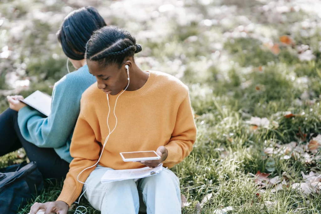 Two people listening to a podcast